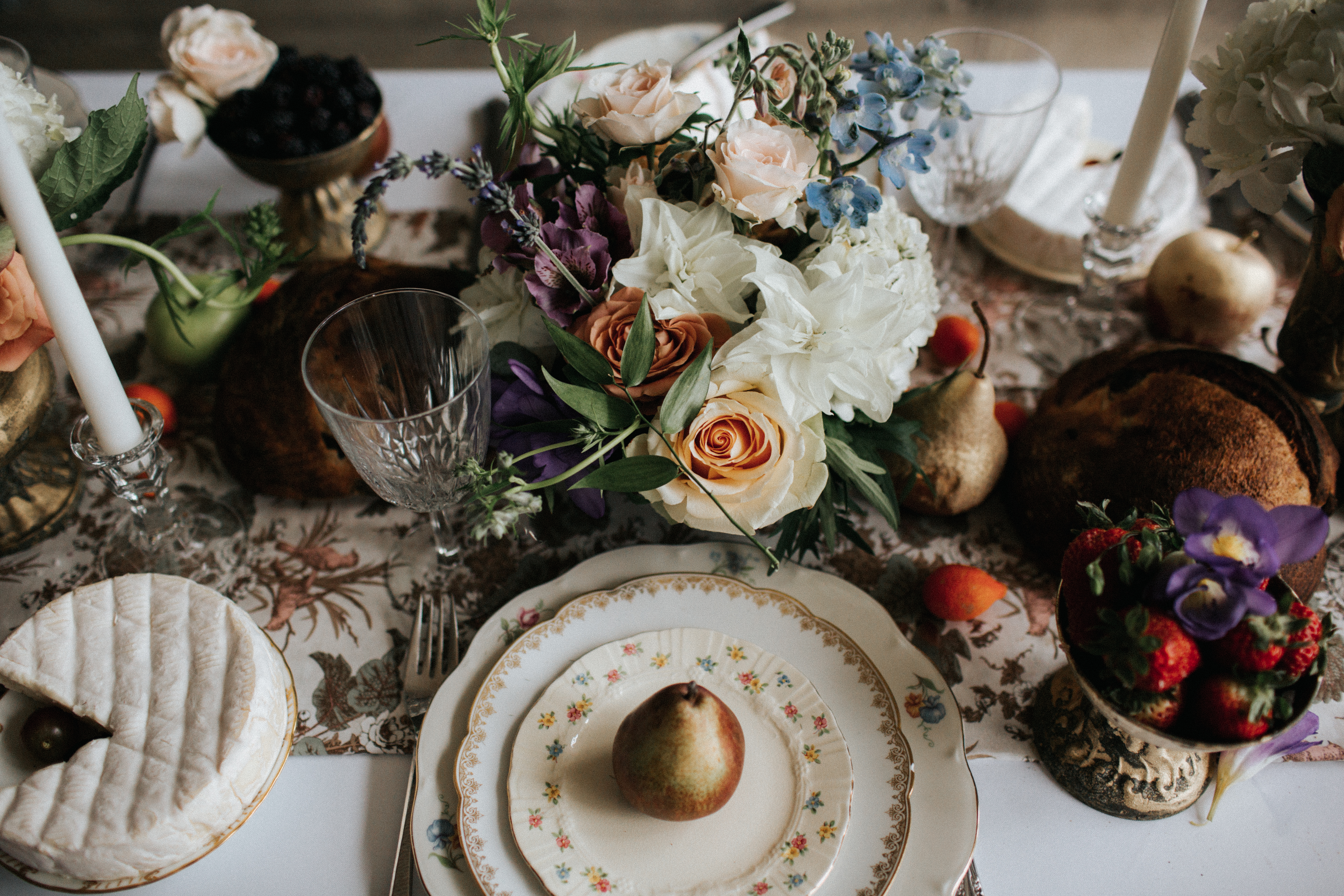 wedding reception place setting and pastel flower arrangements