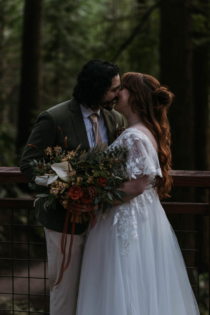 Bride and groom eloping with wedding flowers at hoyt arboretum 